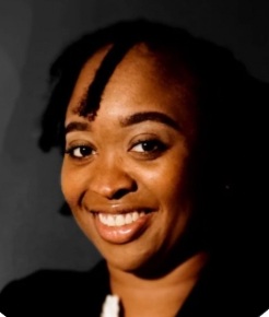 Cassandra Foster smiling warmly in a professional headshot with a neutral background, conveying a friendly and approachable mood